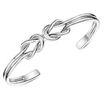 Load image into Gallery viewer, Siilver bangle featuring an elegant interwoven knot design at the center-JOOLS by Jenny Brown
