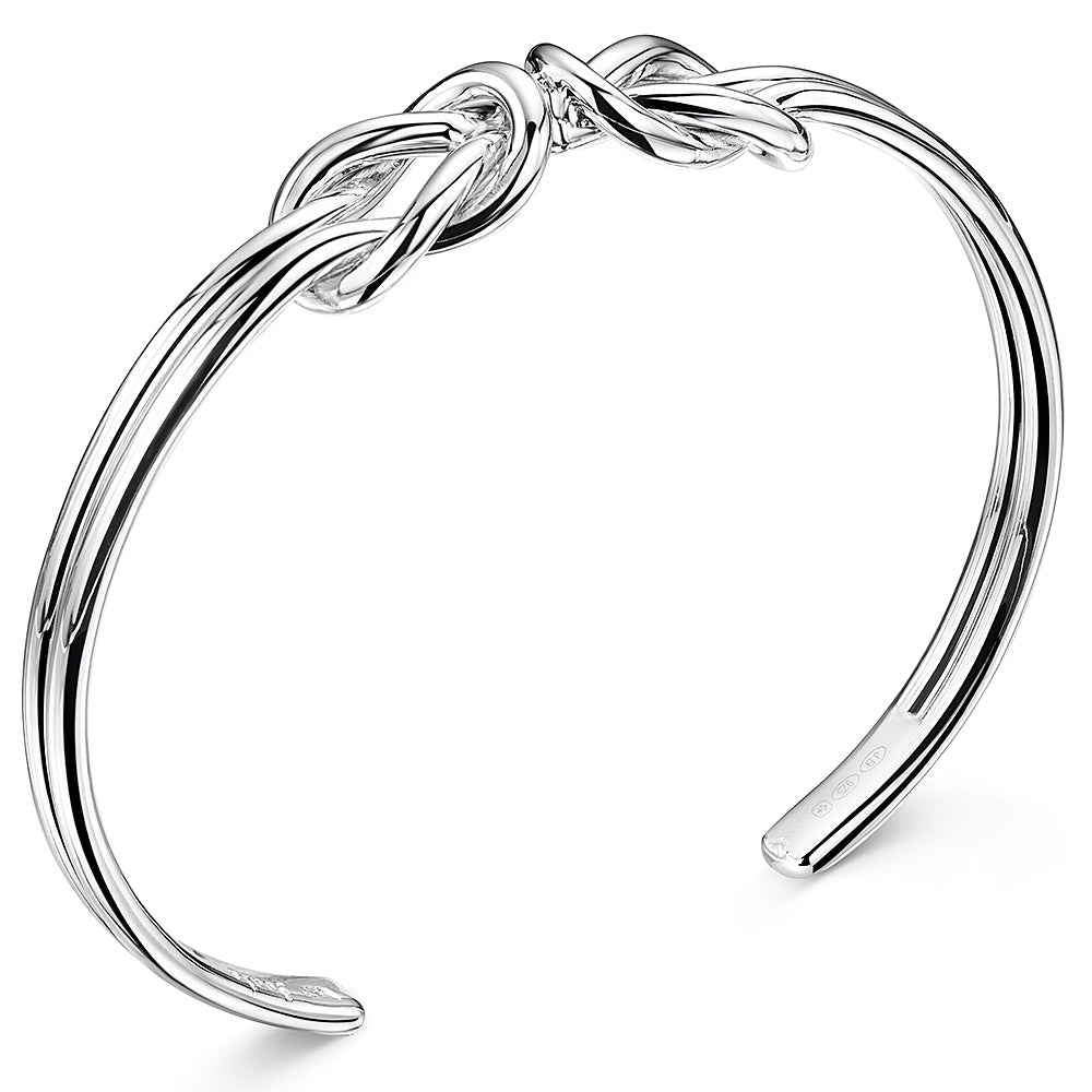 A sterling silver double knot cuff bangle with a high polished finish.