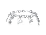 Load image into Gallery viewer, A sterling silver charm bracelet with dangly heart-shaped charms and additional cubic zirconia -JOOLS by Jenny Brown
